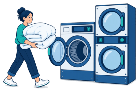 Illustration of a large front-loading washer holding a bulky duvet beside a matching large dryer, with a customer carrying bedding.